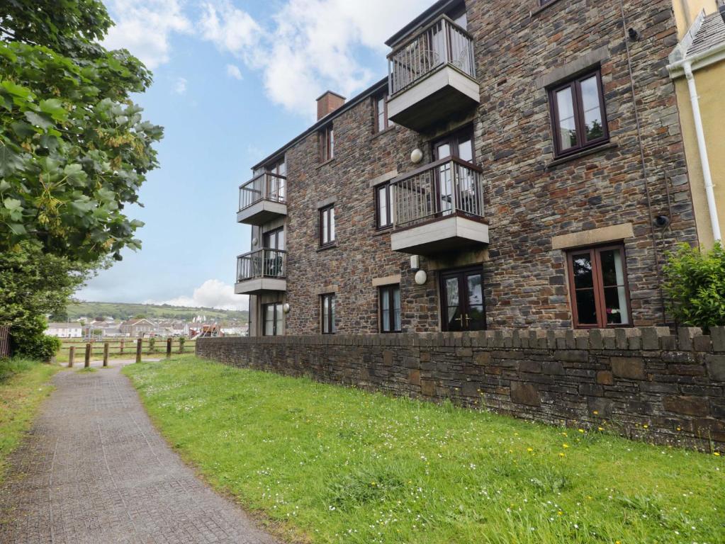 a brick building with balconies on the side of it at Twyni Bach in Burry Port