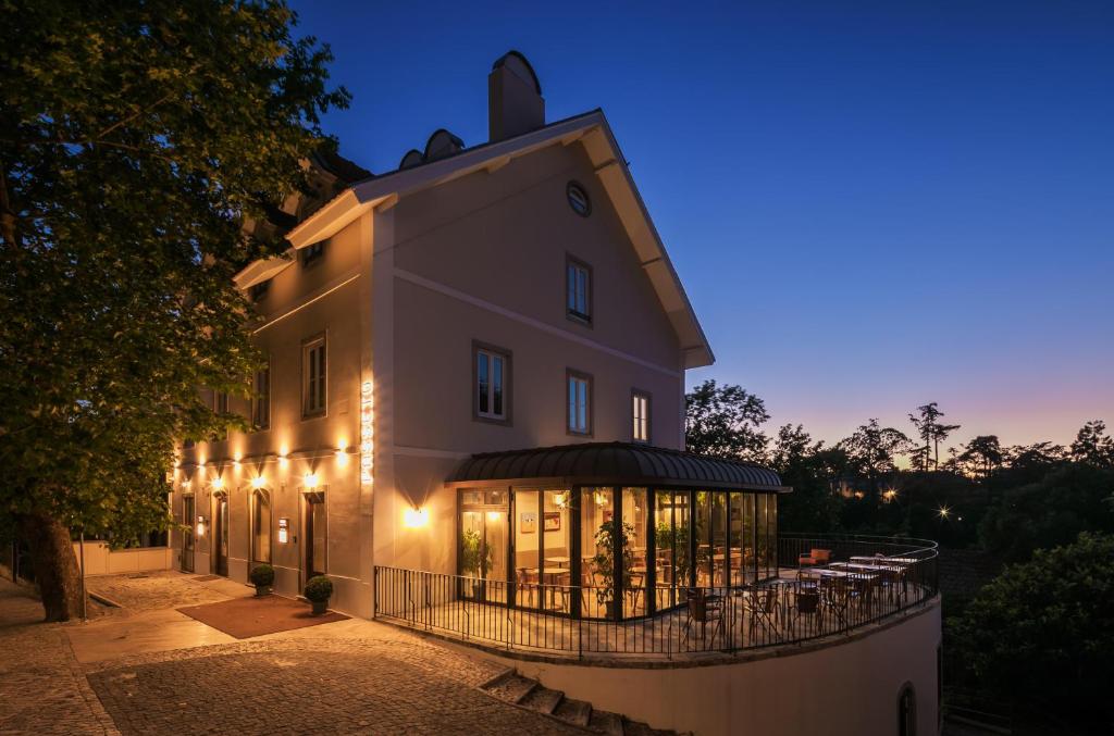 a building with lights on it at night at Passeio Sintra Collection in Sintra