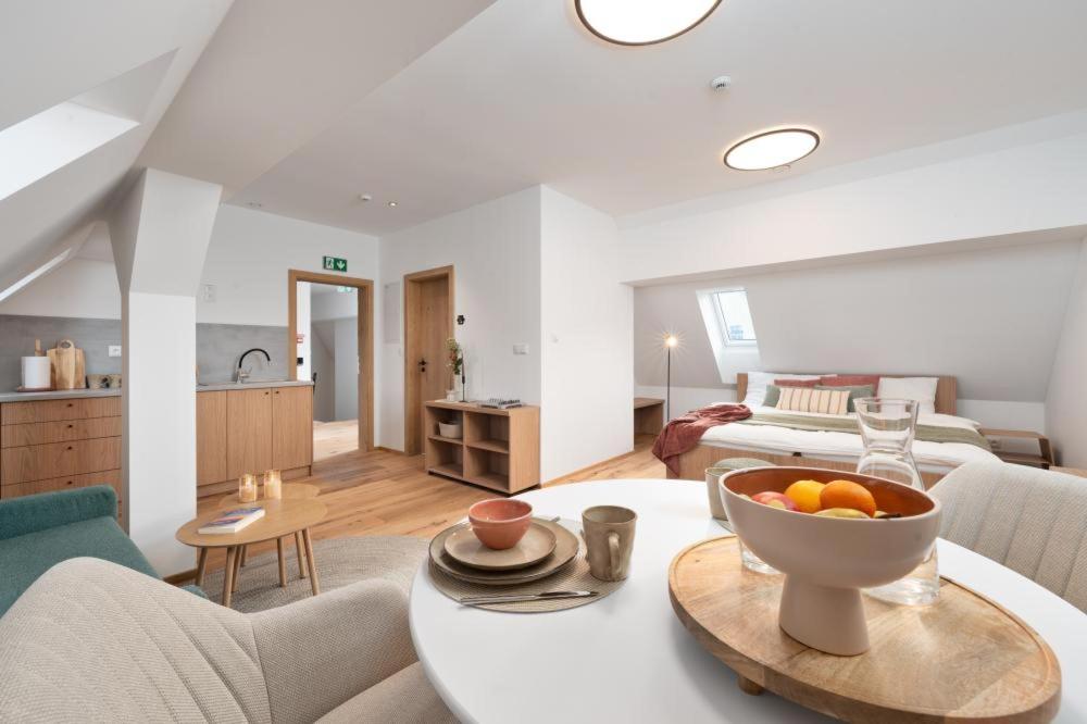 a living room with a table with a bowl of oranges on it at Apartmány Pod Jabloní in Jablonné nad Orlicí