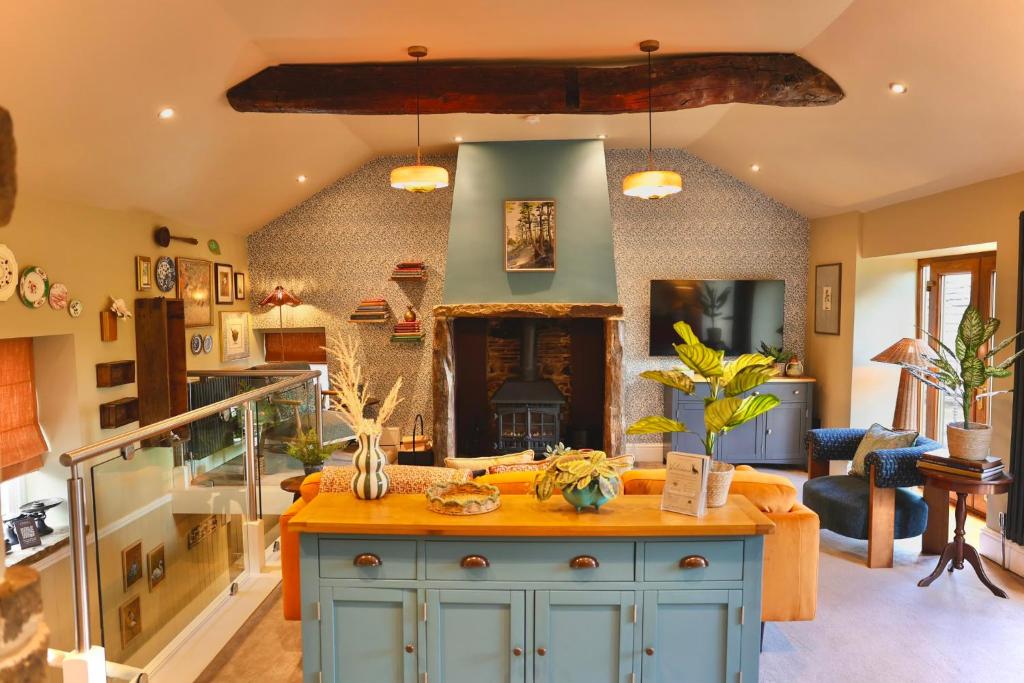 a kitchen with a blue island in a room at Town Gate Cottage in Stainland