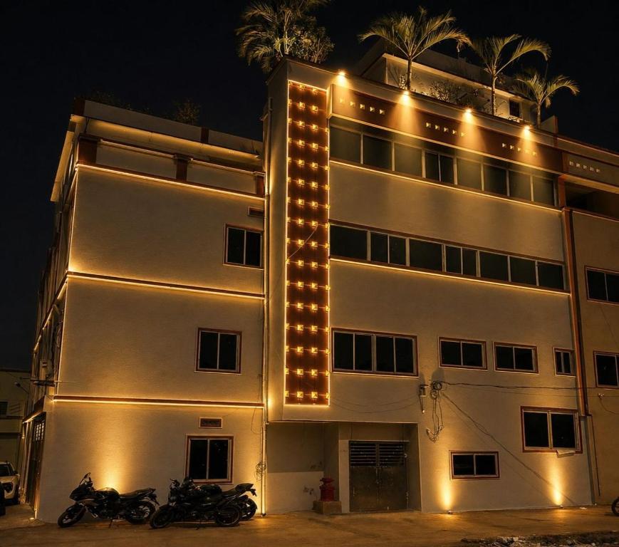 a building with lights on the side of it at Dev'S Inn Luxurious Homestays in Similigurha