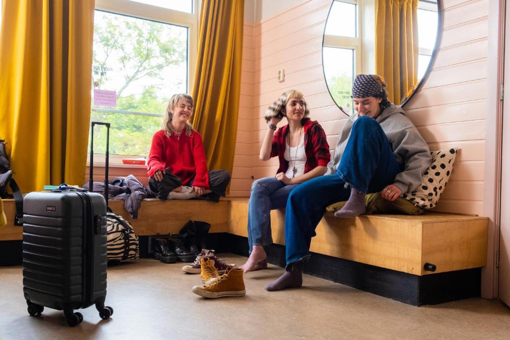 a group of people sitting on beds in a room at Hostel Ani&Haakien in Rotterdam