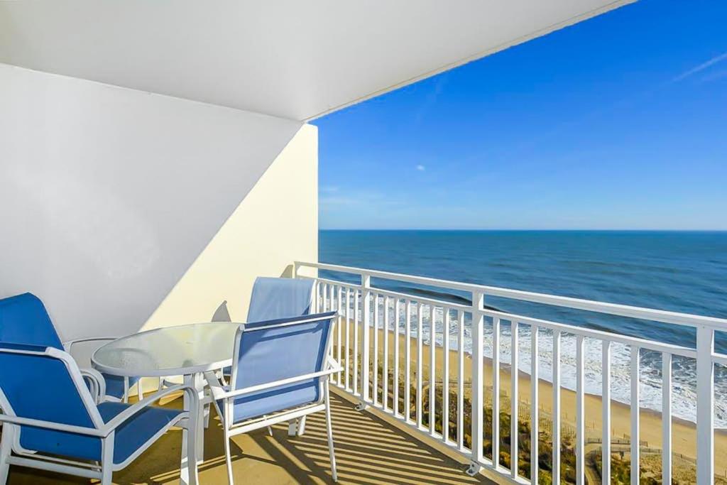 a balcony with chairs and a table and the ocean at Carousel 1905 in Ocean City