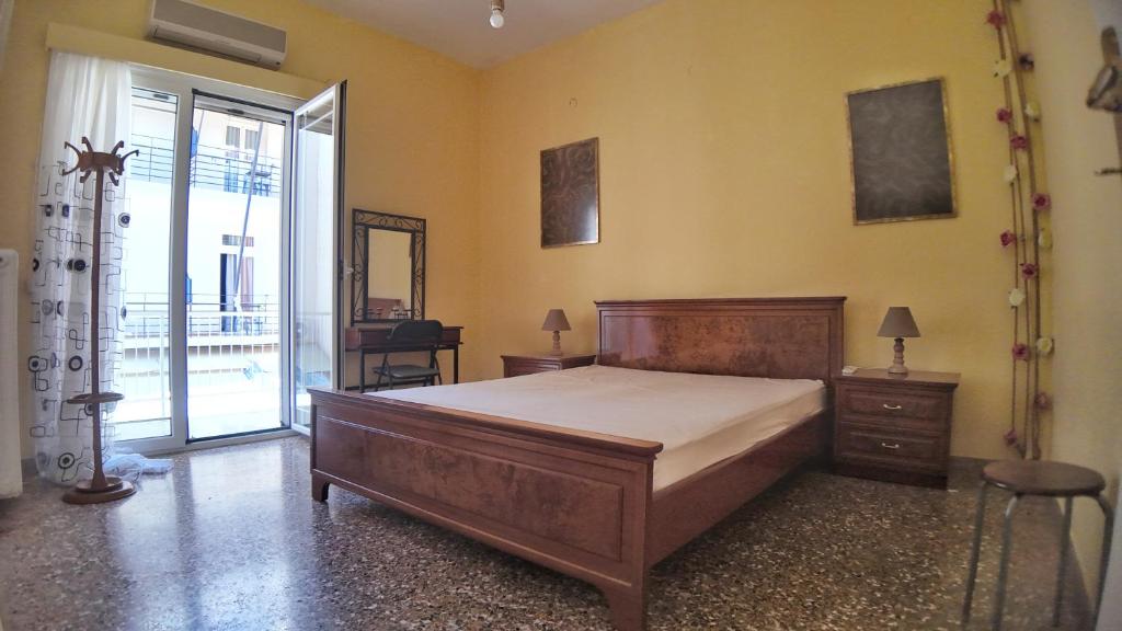 a bedroom with a bed and a sliding glass door at Amelie in Loutraki