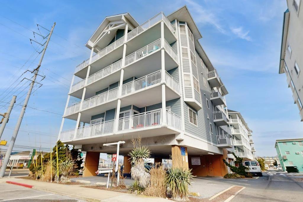 a tall white apartment building on a street at Condo 4100 #201 in Ocean City