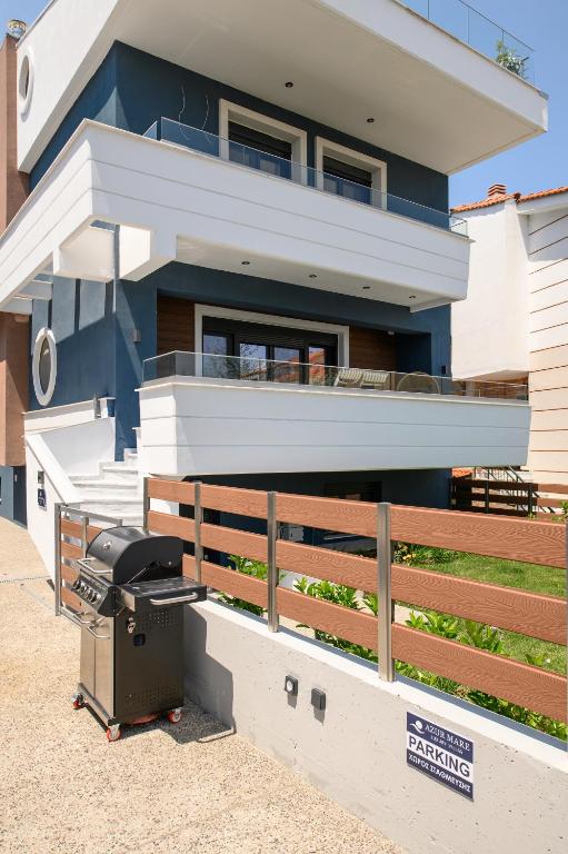 a barbecue grill in front of a house at Azur Mare Luxury Villas in Neoi Epivates