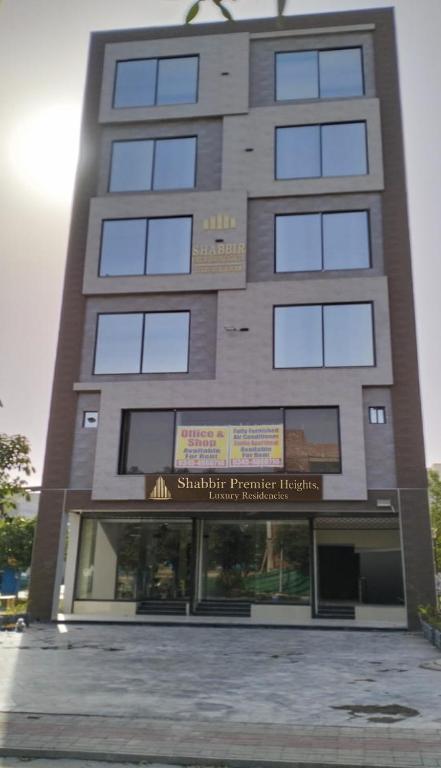 a tall building with windows on the side of it at Shabbir Premier Heights in Lahore