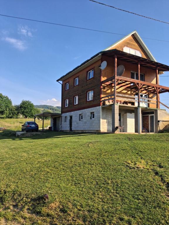 a large barn with a car parked in front of it at Сонячний in Slavske