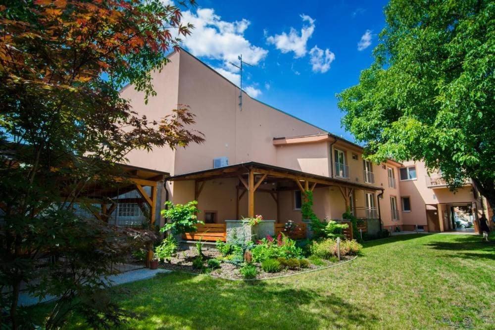 a large house with a yard in front of it at Penzion VV SUN - REOS in Hodonín