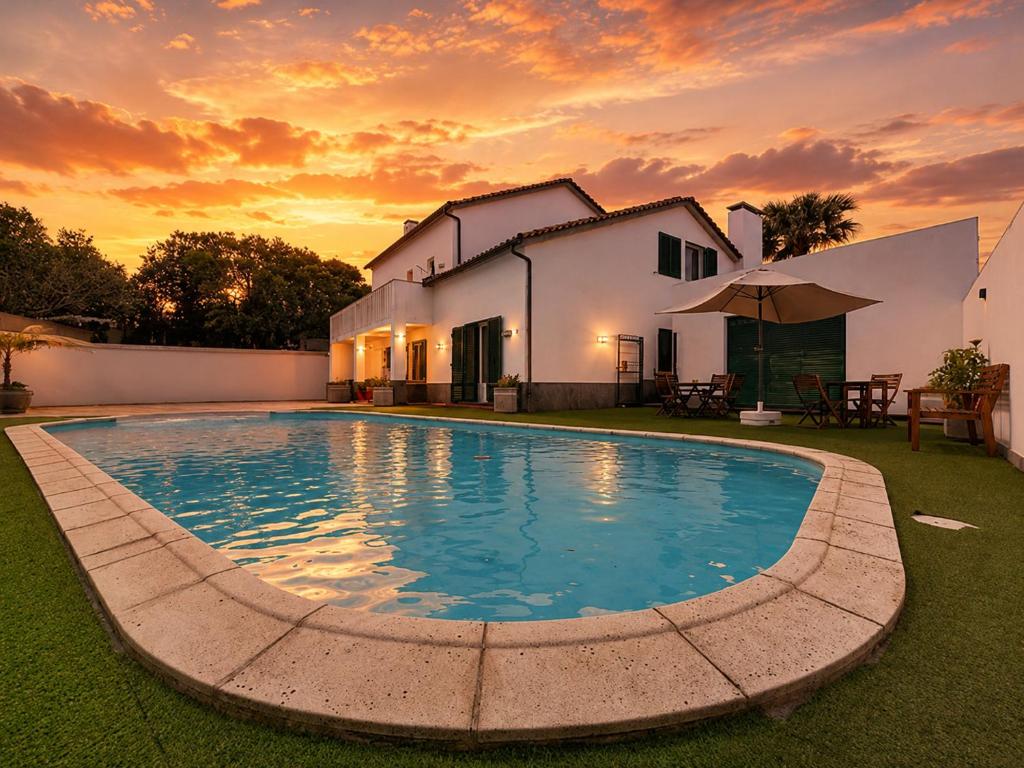 a large swimming pool in front of a house at Casa Vereda Ponta Delgada, S Miguel in Ponta Delgada