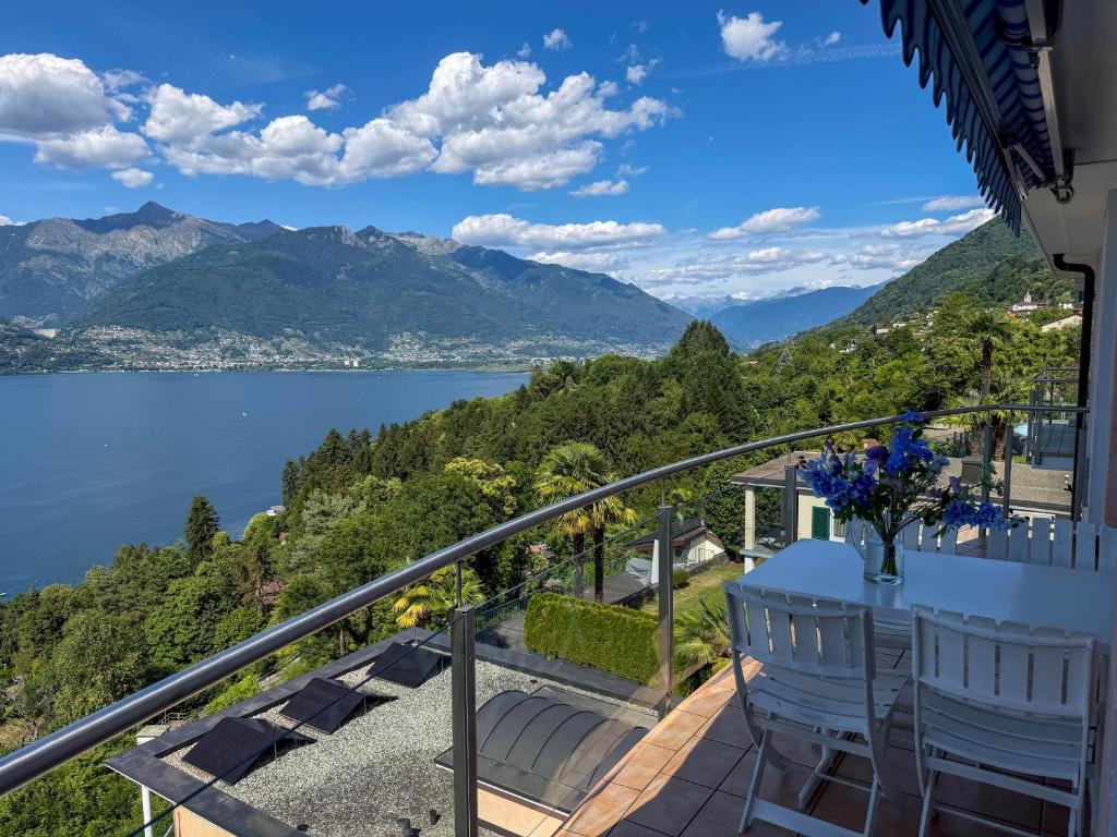a balcony with a view of a lake and mountains at Orizzonte Blu by HolAp SA in Gambarogno