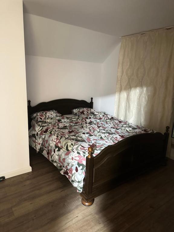a bedroom with a bed with a comforter and a window at Casa Horeb Apuseni in Sohodol