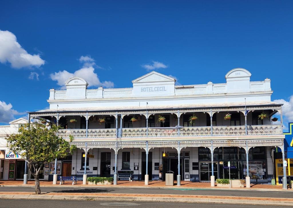 a white building on the corner of a street at Hotel Cecil Wondai in Wondai