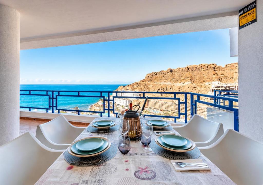 a dining table with a view of the ocean at Roby&Vito Vista Taurito in Taurito