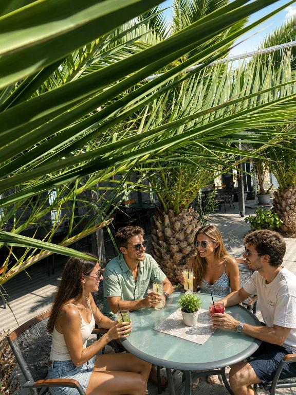 a group of people sitting around a table at Plaza Hotel Plovdiv - Free Parking in Plovdiv