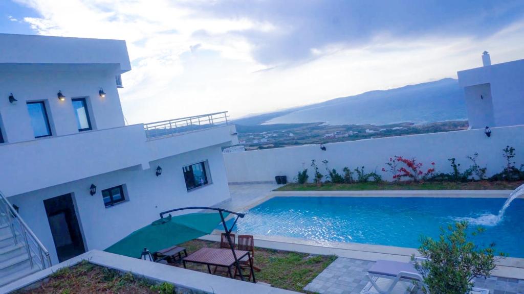 a house with a swimming pool next to a building at Dar Bourri in Al Matlīn