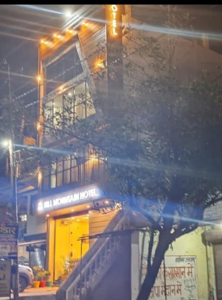 a building at night with a building with lights at Hill Mountain Hotel in Chakarpur