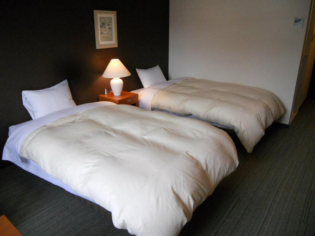 Postel nebo postele na pokoji v ubytování Nikko Station Hotel Classic