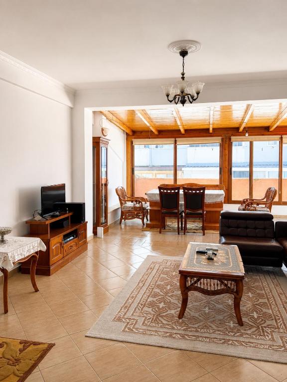 a living room with a couch and a table at Terminal Comfort Apartament in Tirana