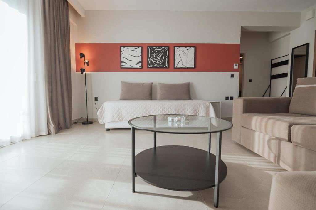 a living room with a bed and a glass table at Likehome Apartments in Orestiada