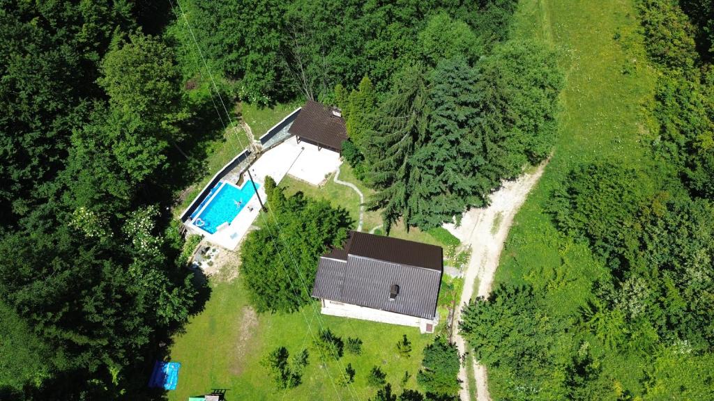 an overhead view of a house with a swimming pool at Maca - vikendica sa bazenom in Ahatovići