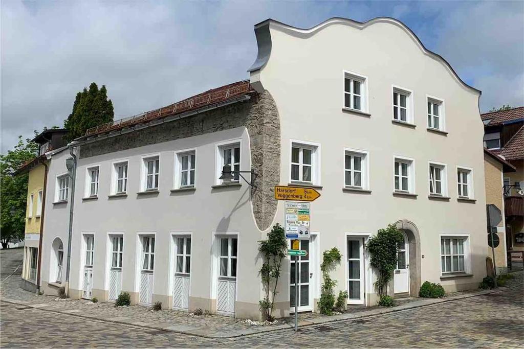 a large white building on a street corner at Wohnhaus am Marktplatz in Röhrnbach in Röhrnbach