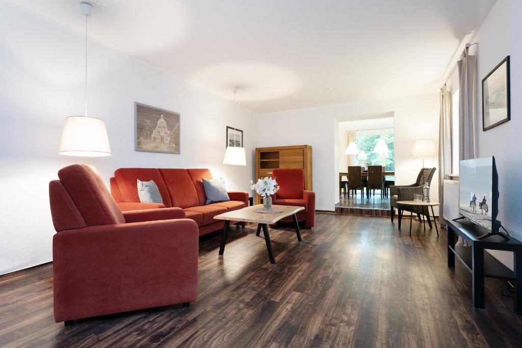 a living room with a couch and a table at Gut Staberhof Staberpark in Staberdorf