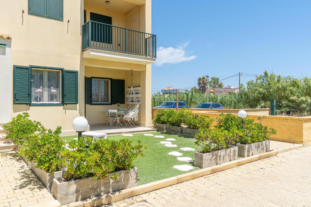 a house with a garden in front of it at La Casa Di Chloe in Marzamemi