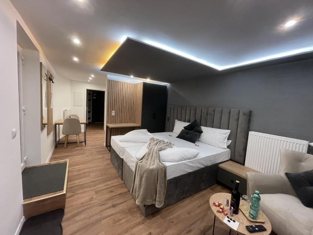 a bedroom with a large bed and a couch at Apartmenthaus Zeuthen 3 in Zeuthen