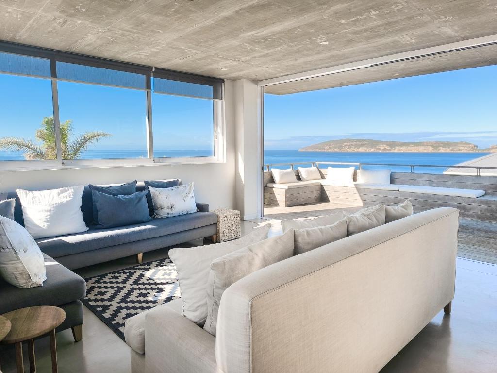a living room with couches and a view of the ocean at Betty in Plettenberg Bay