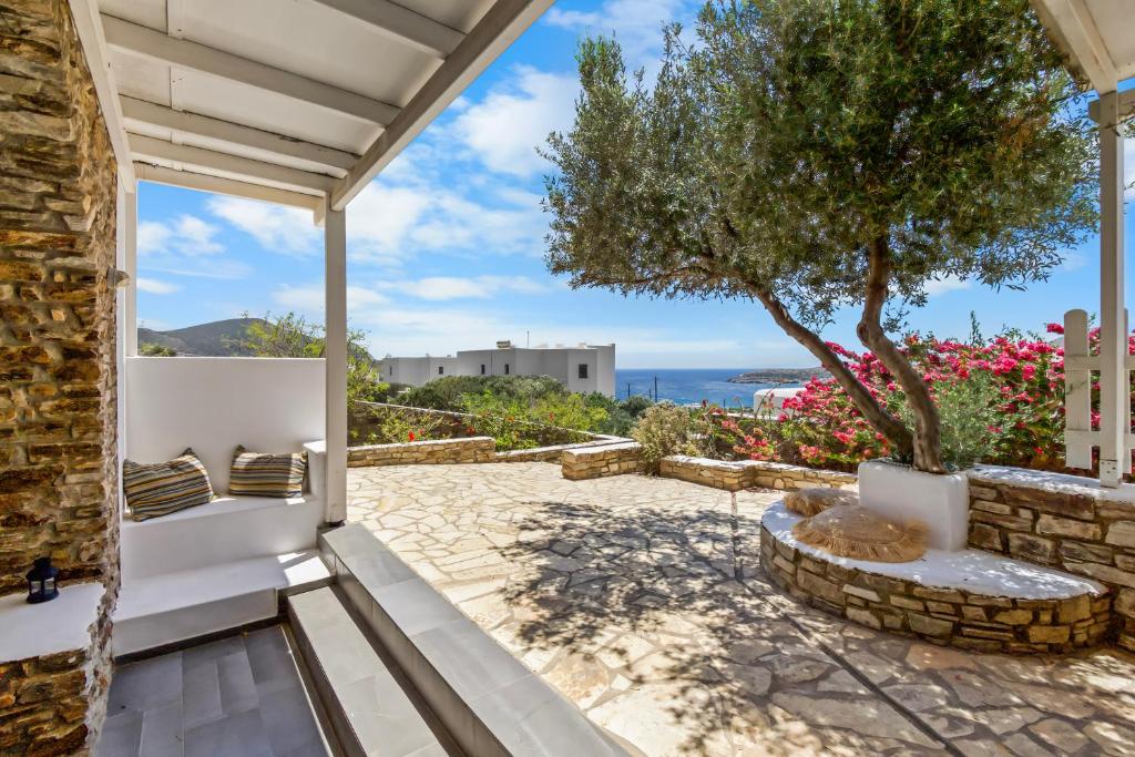 a patio with a view of the ocean from a house at Salty Wind Antiparos Apartments and Studios in Agios Georgios