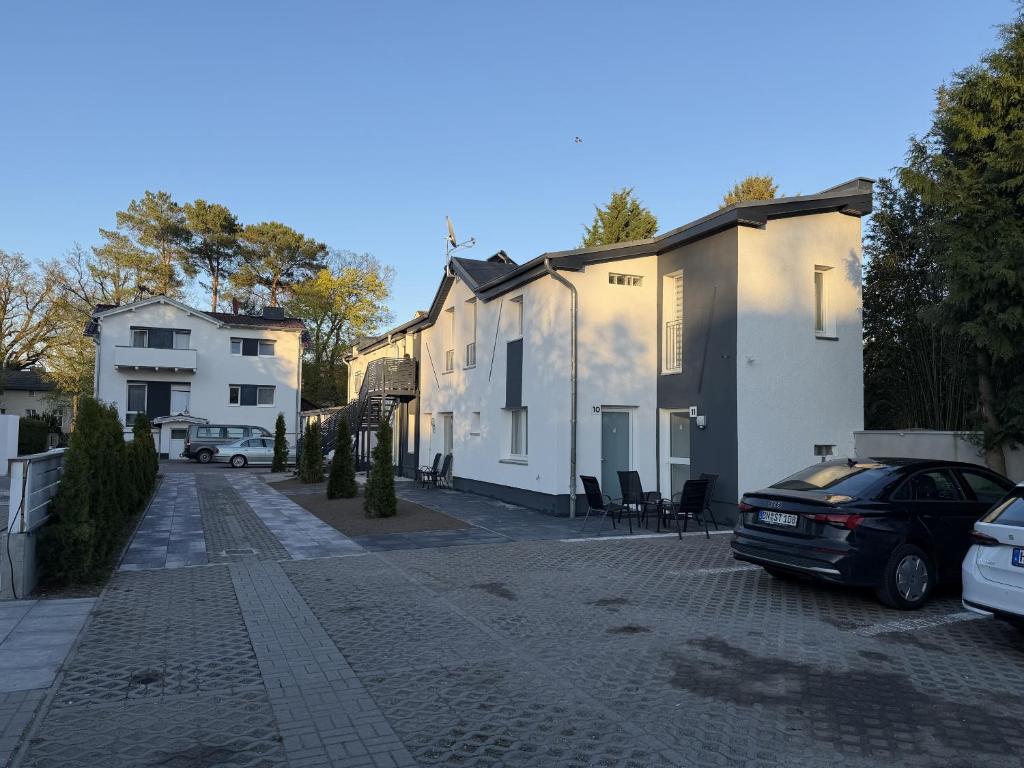 a cobblestone street with houses and a car parked at Apartmenthaus Zeuthen 2 in Zeuthen