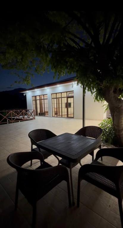 a picnic table and two chairs in front of a building at Relocation Dili House in Dilijan