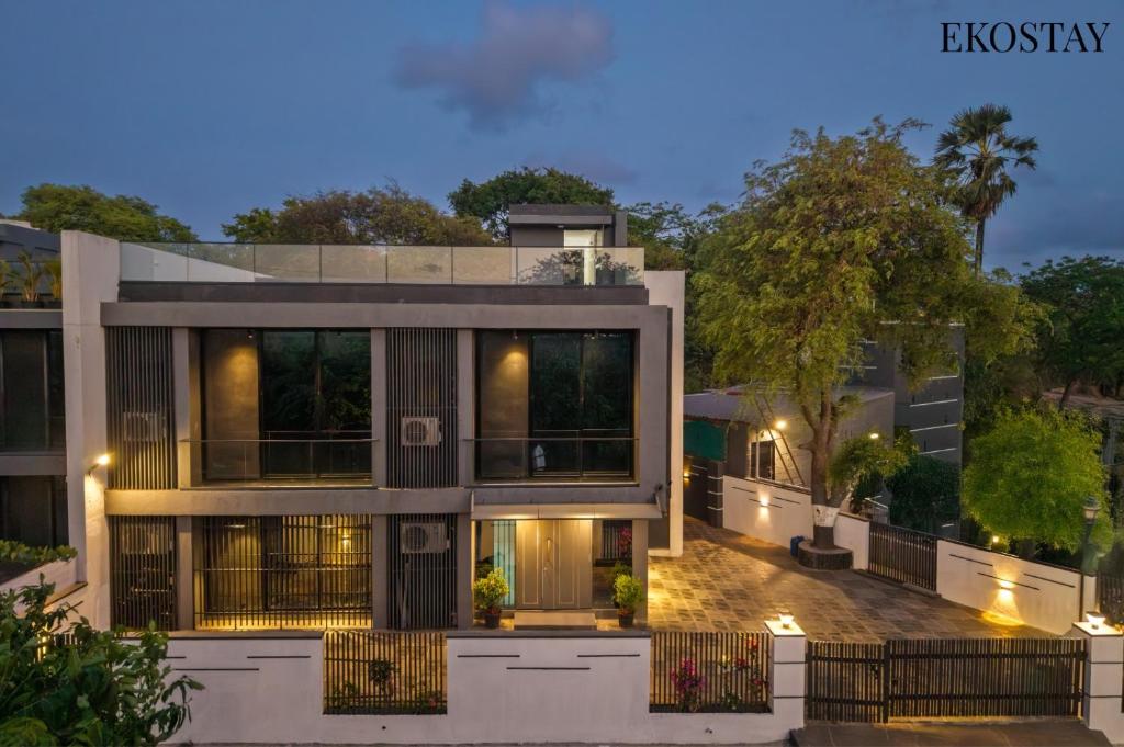 an exterior view of a house at night at EKOSTAY - ONYX Villa in Mumbai