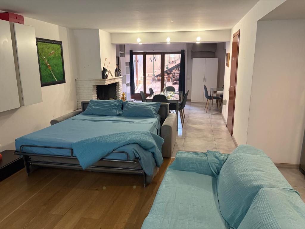 a bedroom with two beds and a living room at Monolocale Zefiro in Elmas