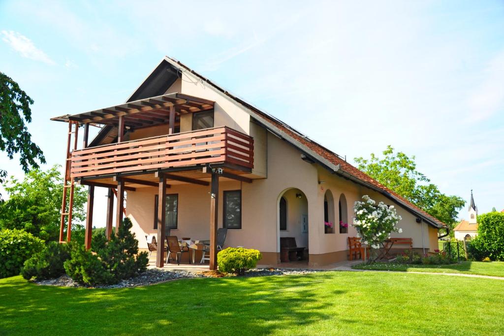 a house with a porch and a green yard at Green Touch in Ivanjkovci