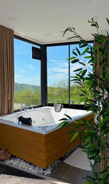 a bath tub in a room with a large window at Montana Resort Otel in Trabzon