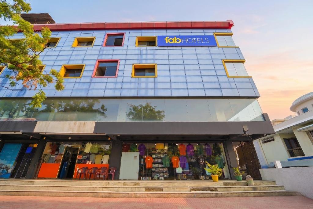 a store front of a building with a sign on it at FabHotel Sca - Gandhipuram in Coimbatore