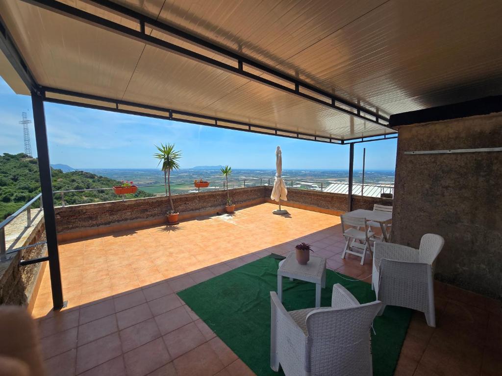 a patio with a view of the ocean from a house at Alloggio turistico - Sole dall'alba al tramonto in Sezze