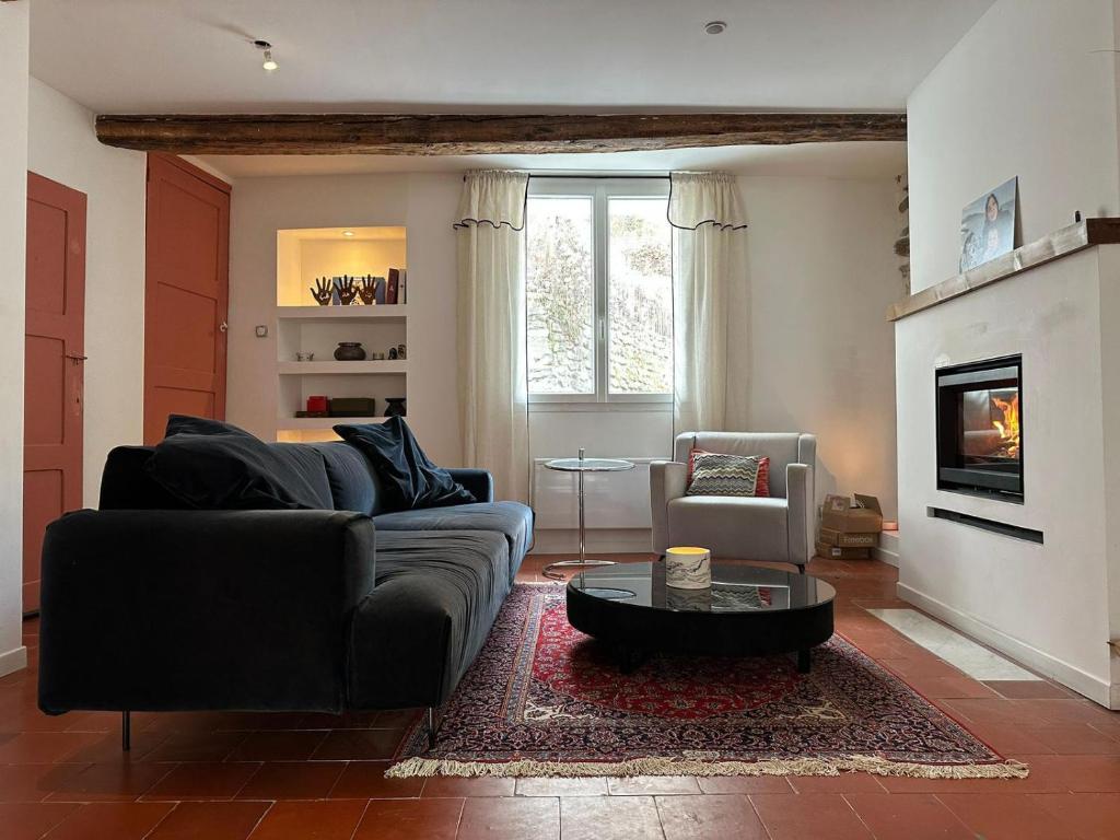 a living room with a couch and a table at Fajureya House in Vaumeilh