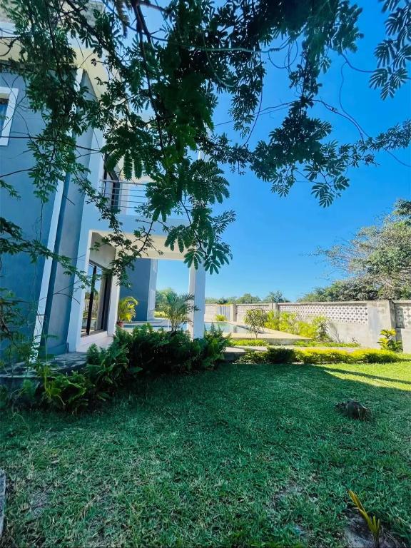 a house with a lawn in front of it at Roof View Macaneta in Praia de Macaneta