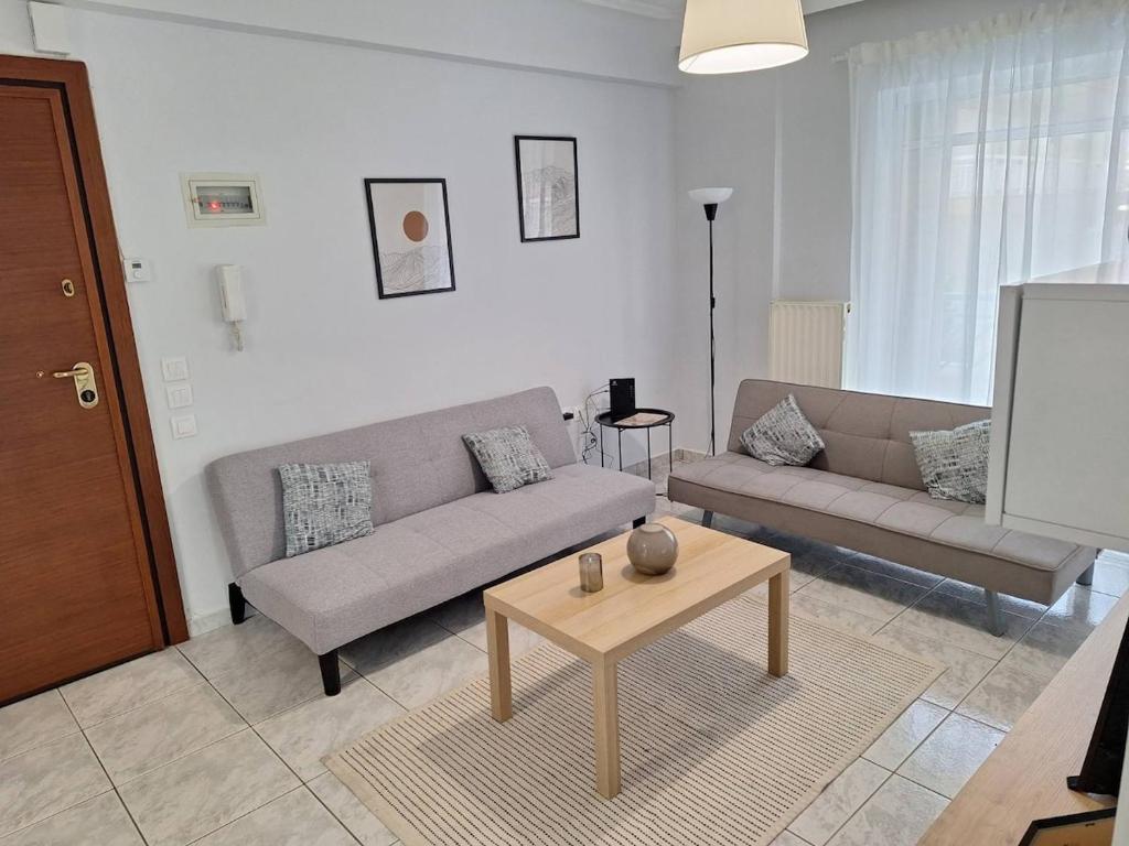 a living room with a couch and a table at Elia rooms in Neoi Epivates