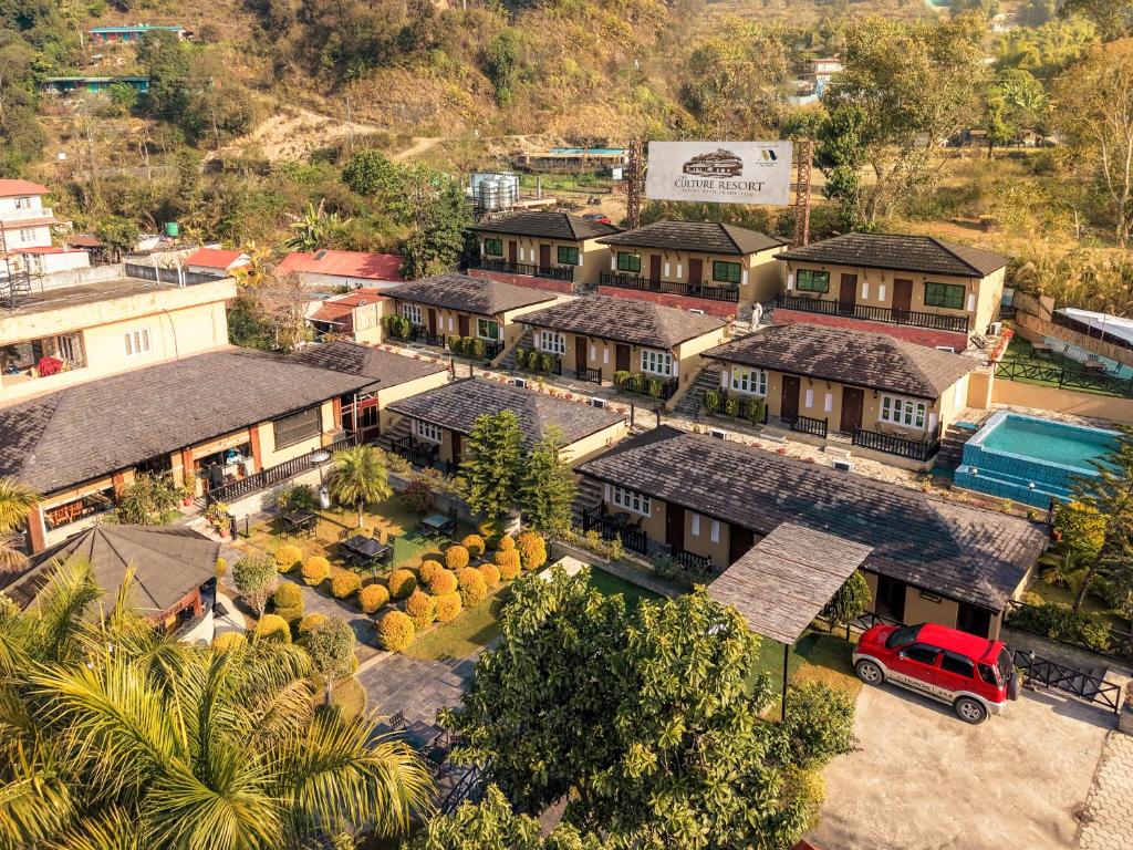 an overhead view of a house with a red truck parked in front at The Culture Resort in Pokhara