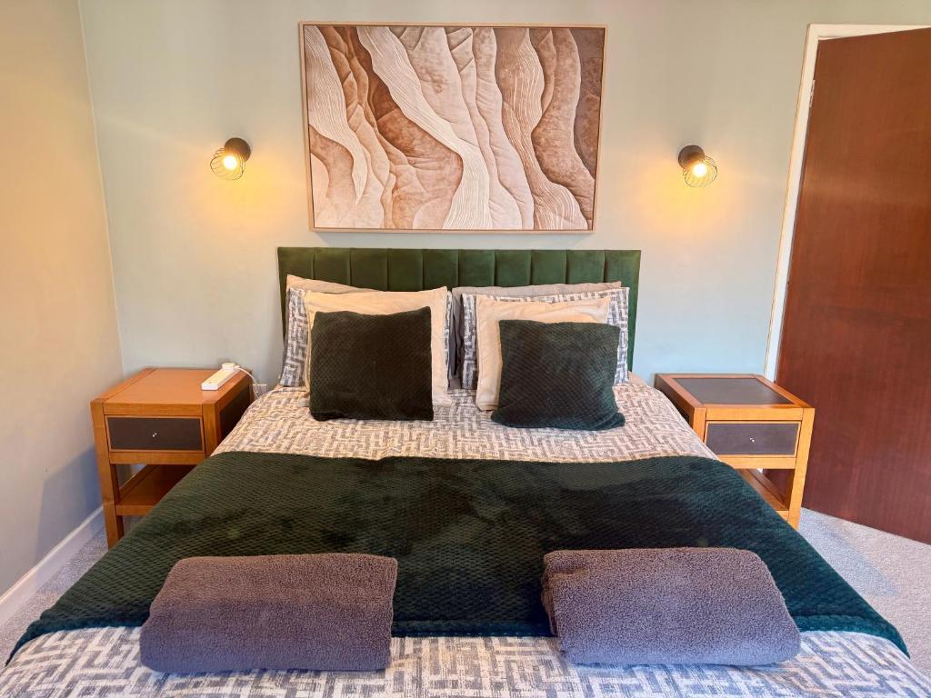 a bedroom with a large bed with two night stands at Bayfields house by the Sea, parking, garden, central location in Portsmouth
