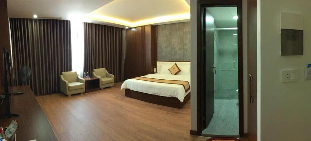 a hotel room with a bed and a mirror at Tv Hotel in Cao Bằng