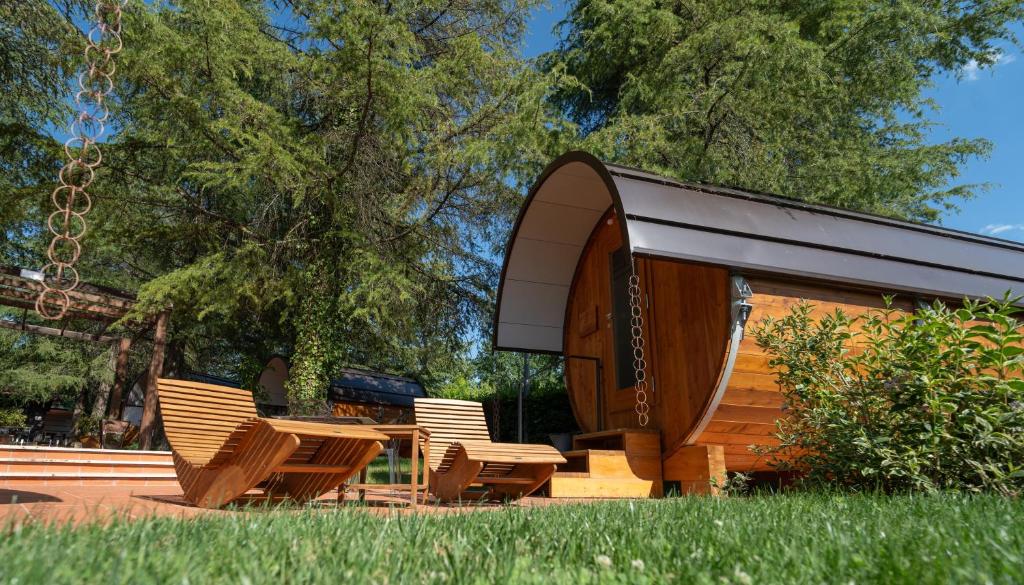 a group of chairs sitting next to a pavilion at Rifugio diVino Dormire in una botte - Wine Barrel stay near Rome in Rieti