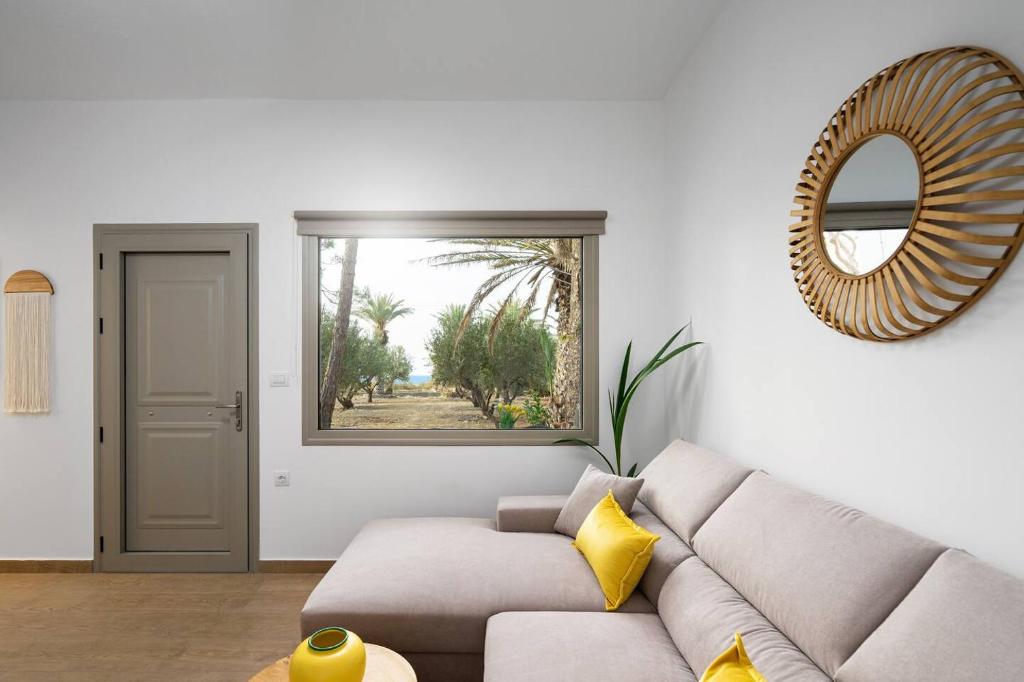 a living room with a couch and a mirror at Lemoni House in Petras, Sitia, by Comfortbnb in Sitia