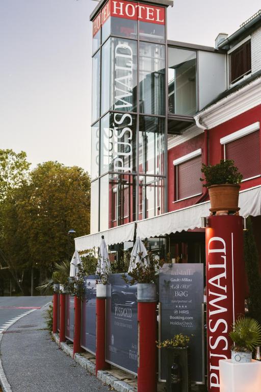 a hotel with a sign on the side of a street at Hotel Restaurant Pusswald in Hartberg