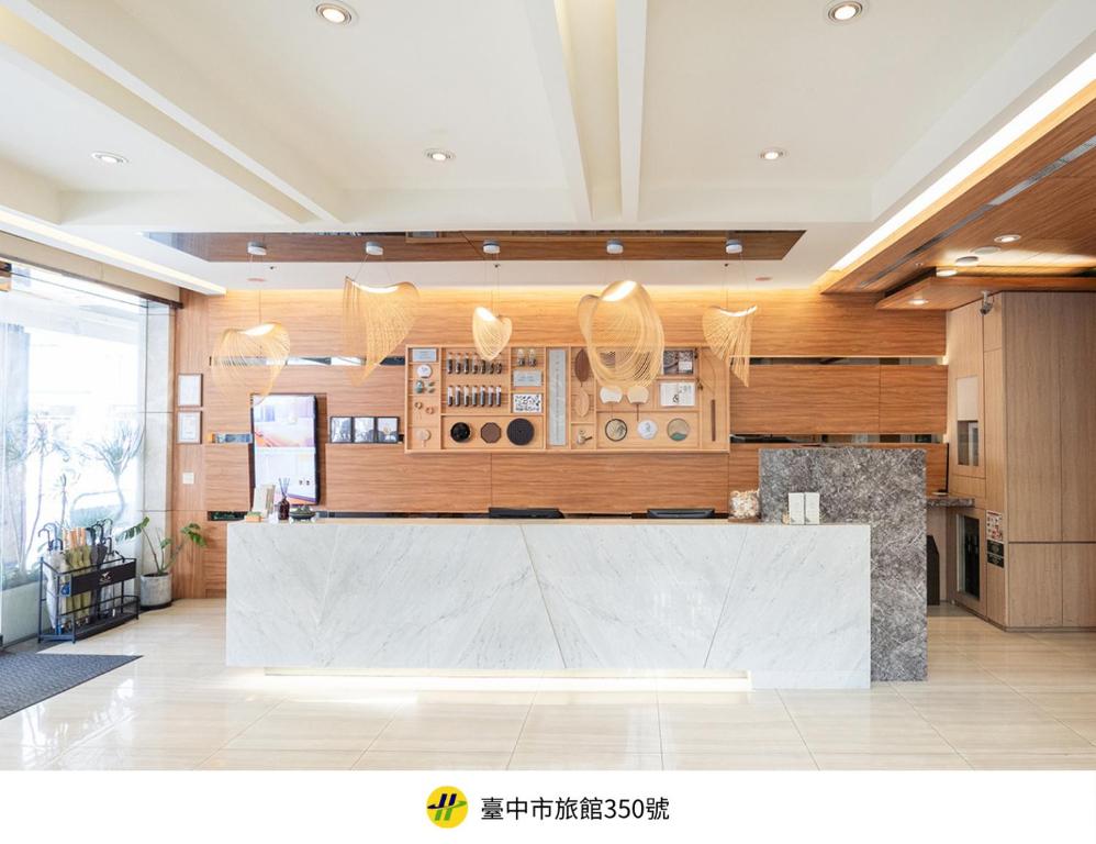 a large kitchen with a large counter in a room at Green Hotel - Tea Way in Taichung
