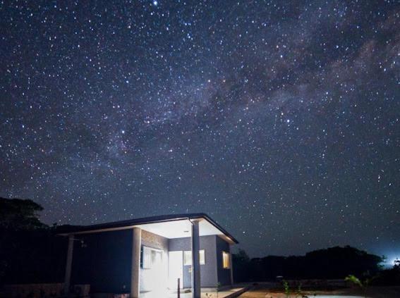 a small building under a starry sky at night at Sea Sky 赤崎 in Yoron